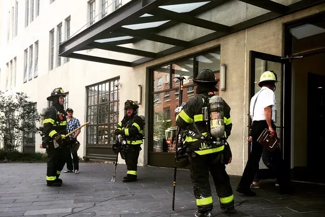 Firefighters outside the luxury apartment building at 184 Kent Avenue after the second of five fires there, in June.
